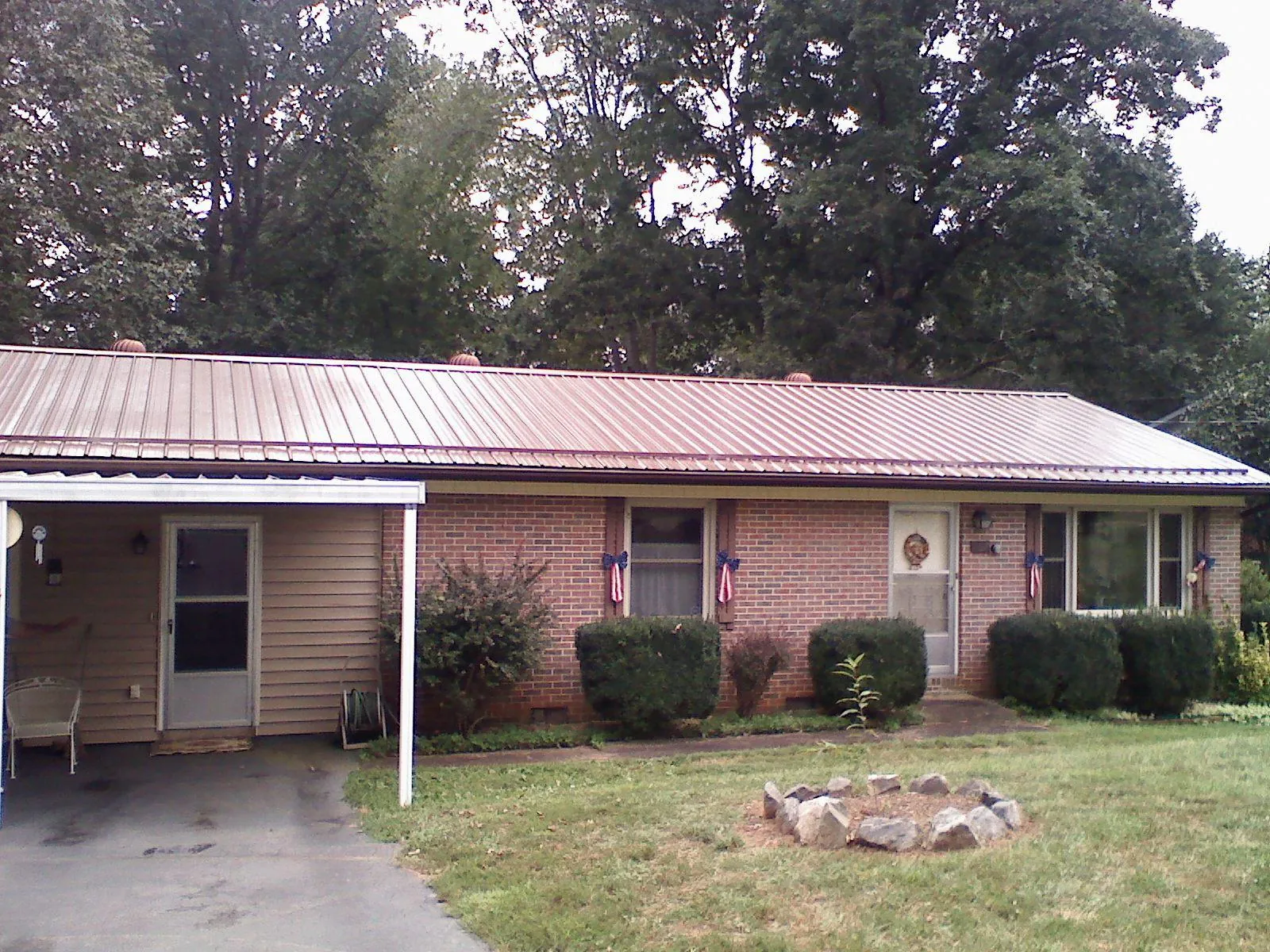 Bronze metal roof and carport on a brick ranch home — Roof Repair work by our crew in Seaside Heights